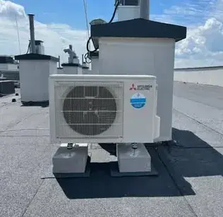 Jednostka zewnętrzna Mitsubishi Electric na płaskim dachu
